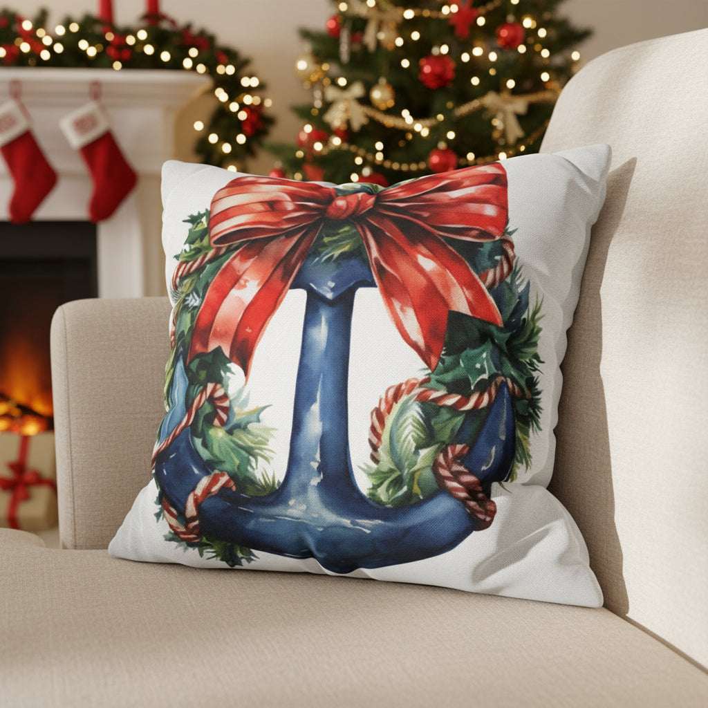 Decorative white pillow with a blue anchor with a red bow on a couch.