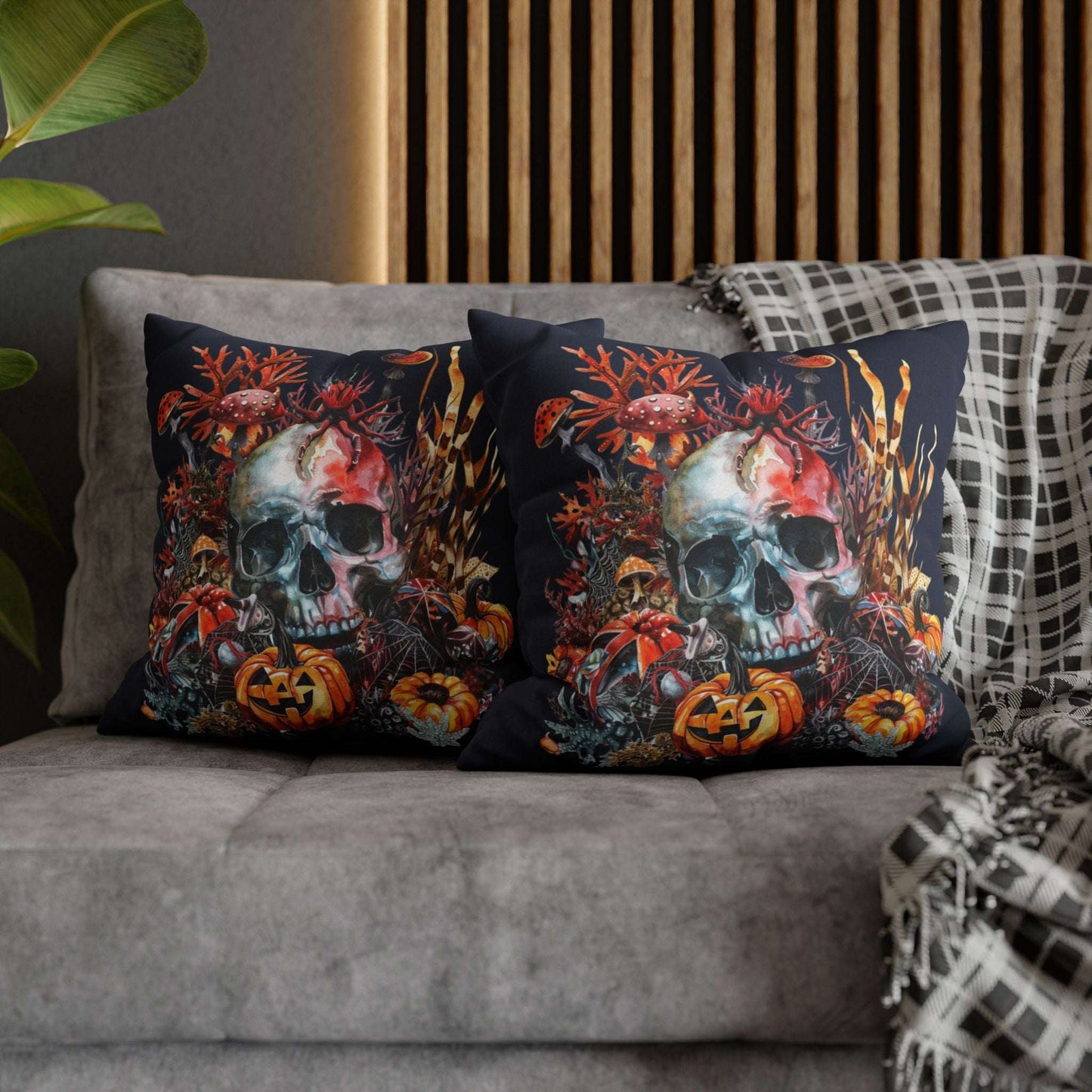 Decorative pillow cases with a double-sided  design of a skull and pumpkins design on a dark background.