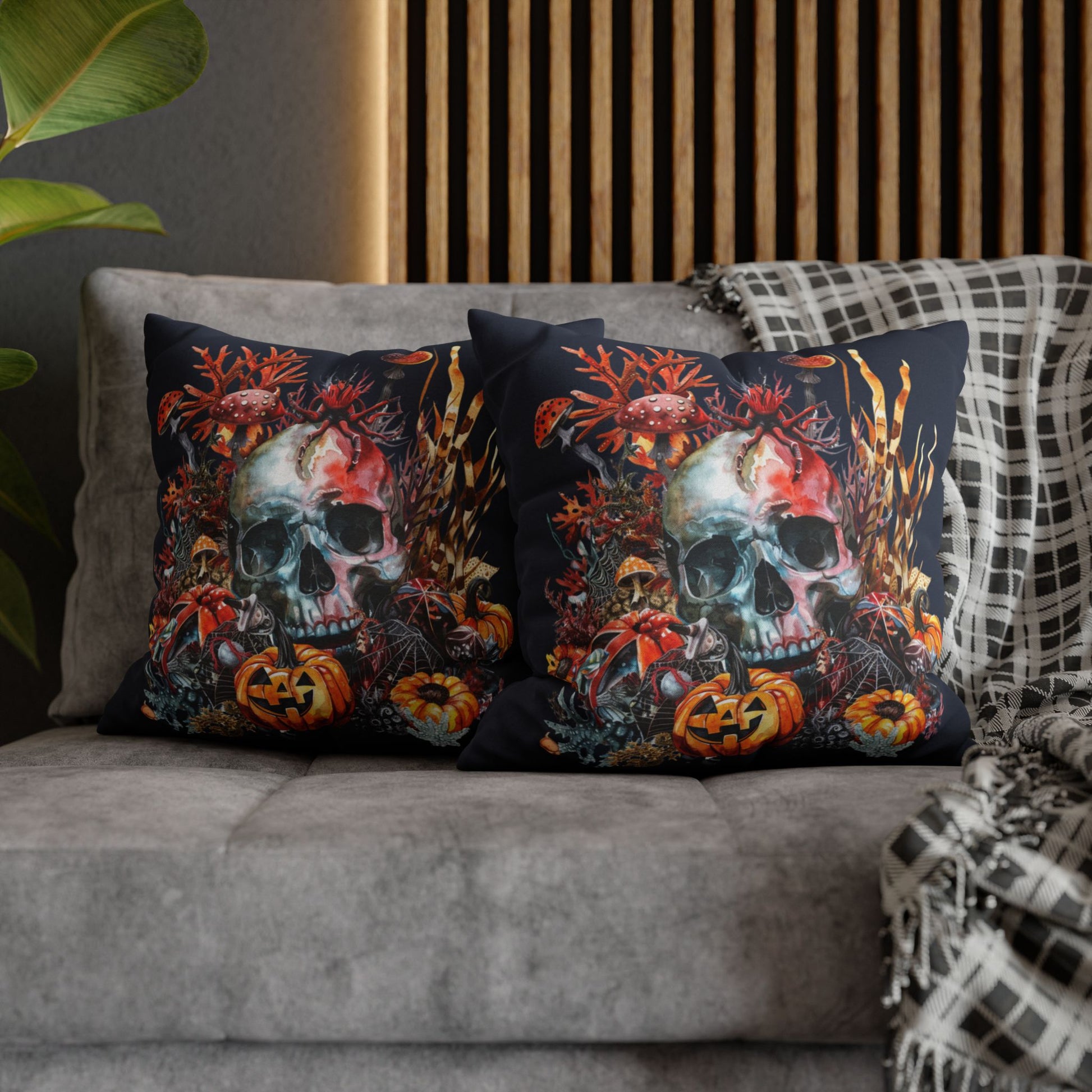 Decorative pillow cases with a double-sided  design of a skull and pumpkins design on a dark background.