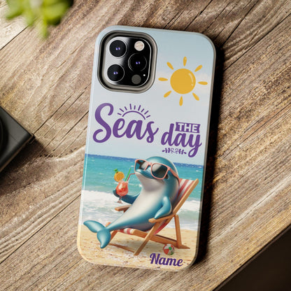 Seas the Day dolphin-themed phone case with personalized name, glossy finish, and beach-inspired design with a dolphin enjoying a cocktail during a sunny day on the beach with the phrase Seas the Day. 