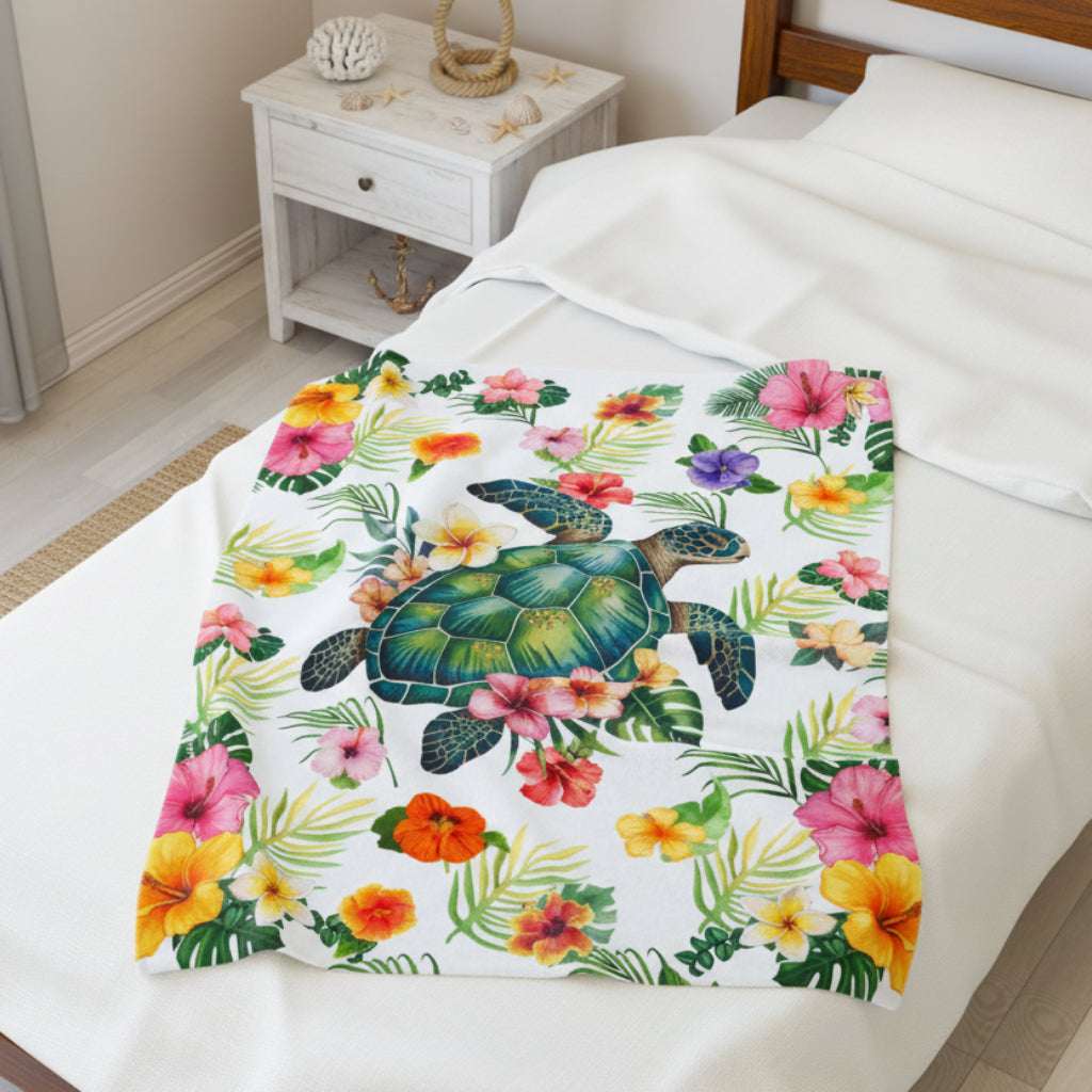 Cozy tropical velveteen 30x40 throw blanket featuring a sea turtle surrounded by colorful hibiscus flowers and palm leaves, perfect for beachy home decor.