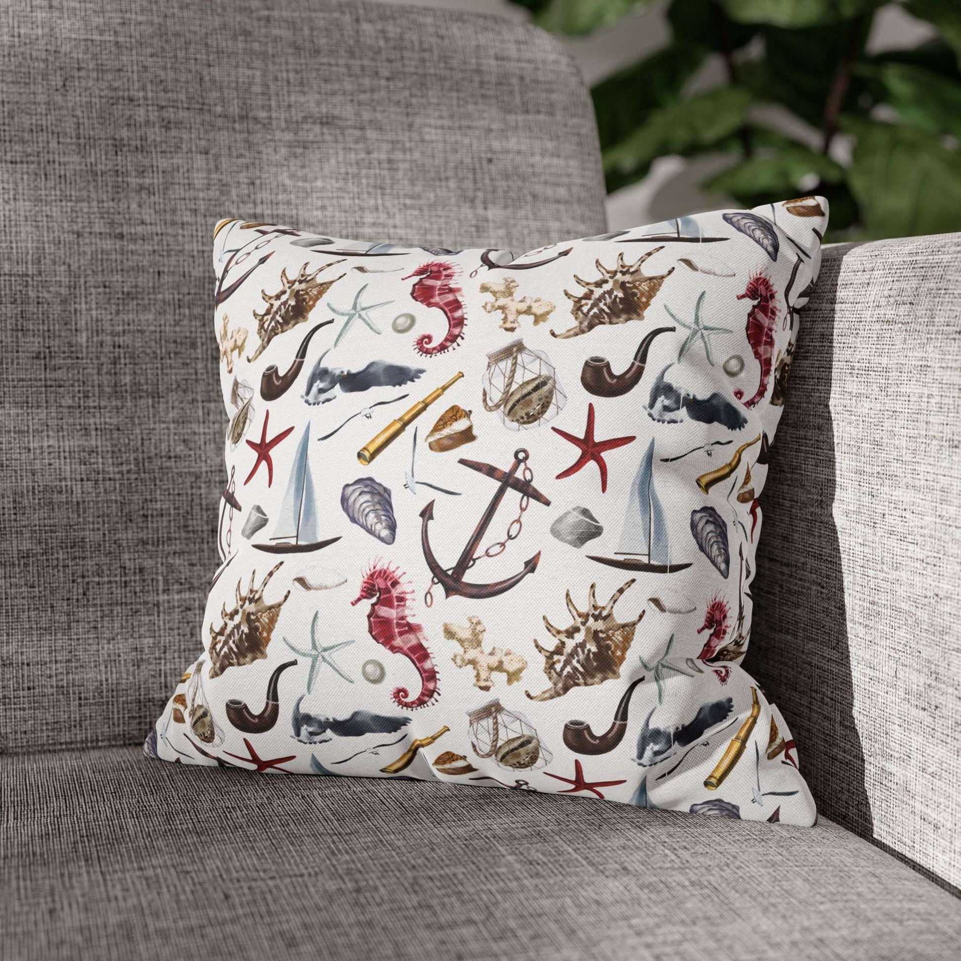 14" x 14" white pillowcase featuring detailed graphics of anchors, seashells, sailboats, and seahorses in a nautical-themed pattern.