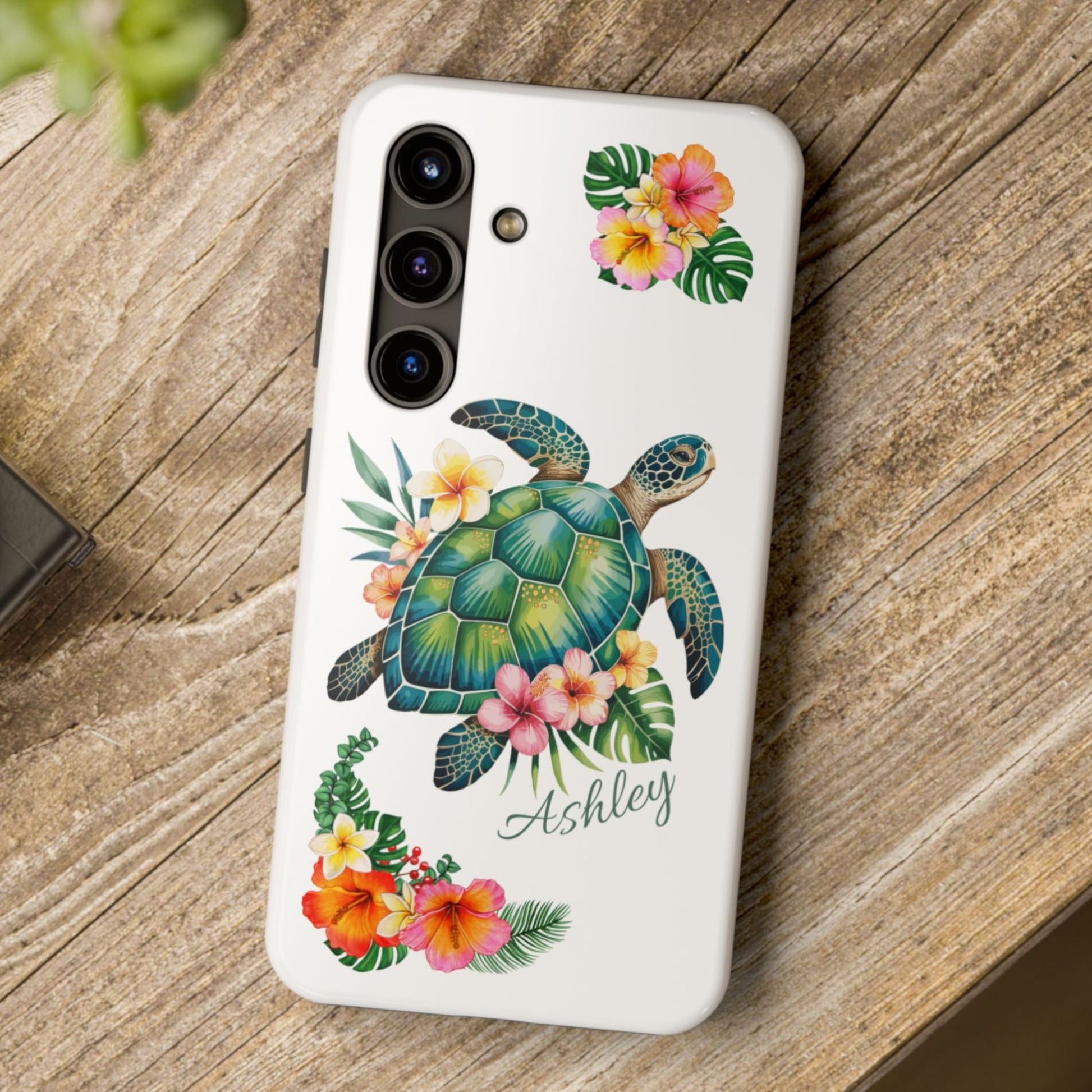 Samsung phone case with a white background and a sea turtle with hibiscus flowers, with more hibiscus flowers around the sides.