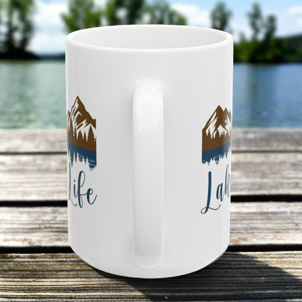 Side handle view of our white 15 oz. ceramic mug with mountain and lake reflection design, featuring the phrase “Lake Life” – perfect for nature lovers.