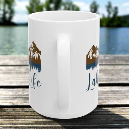 Side handle view of our white 15 oz. ceramic mug with mountain and lake reflection design, featuring the phrase “Lake Life” – perfect for nature lovers.