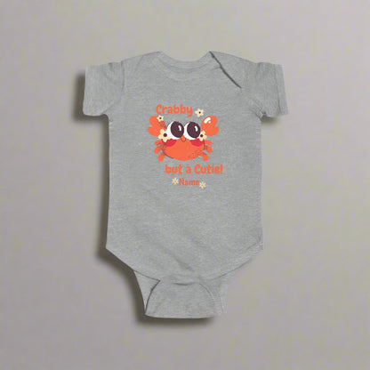 Gray short-sleeved bodysuit with cartoon crab that says crabby but a cutie with a space for a personalized name below.