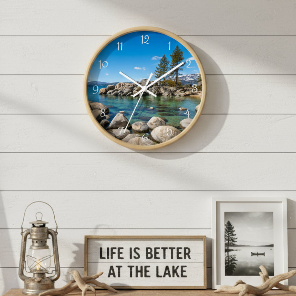 Round wall clock with a scenic design of a lake and trees on a white background