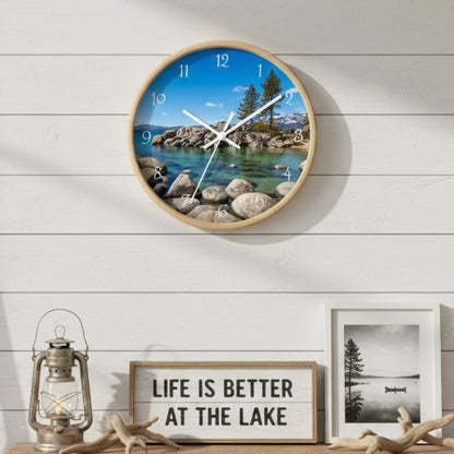 Round wall clock with a scenic design of a lake and trees on a white background