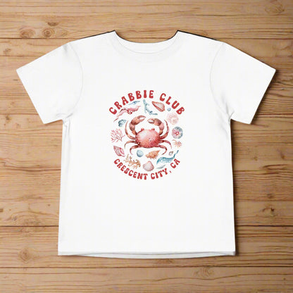 White Toddler t-shirt with the phrase “Crabbie Club Crescent City, CA” and a playful cartoon crab graphic.