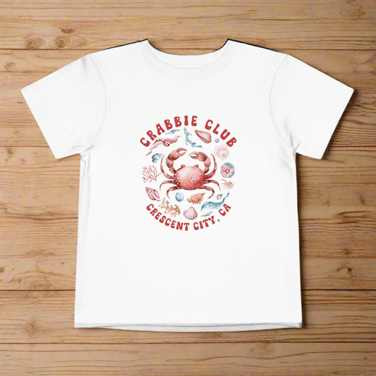 White Toddler t-shirt with the phrase “Crabbie Club Crescent City, CA” and a playful cartoon crab graphic.