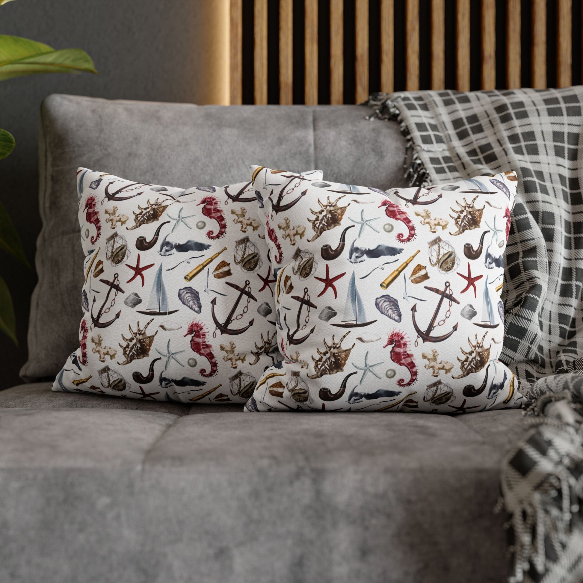 Two 14" x 14" white pillowcases featuring detailed graphics of anchors, seashells, sailboats, and seahorses in a nautical-themed pattern.