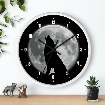 Wall clock with a wolf howling at the moon design on a white wall.