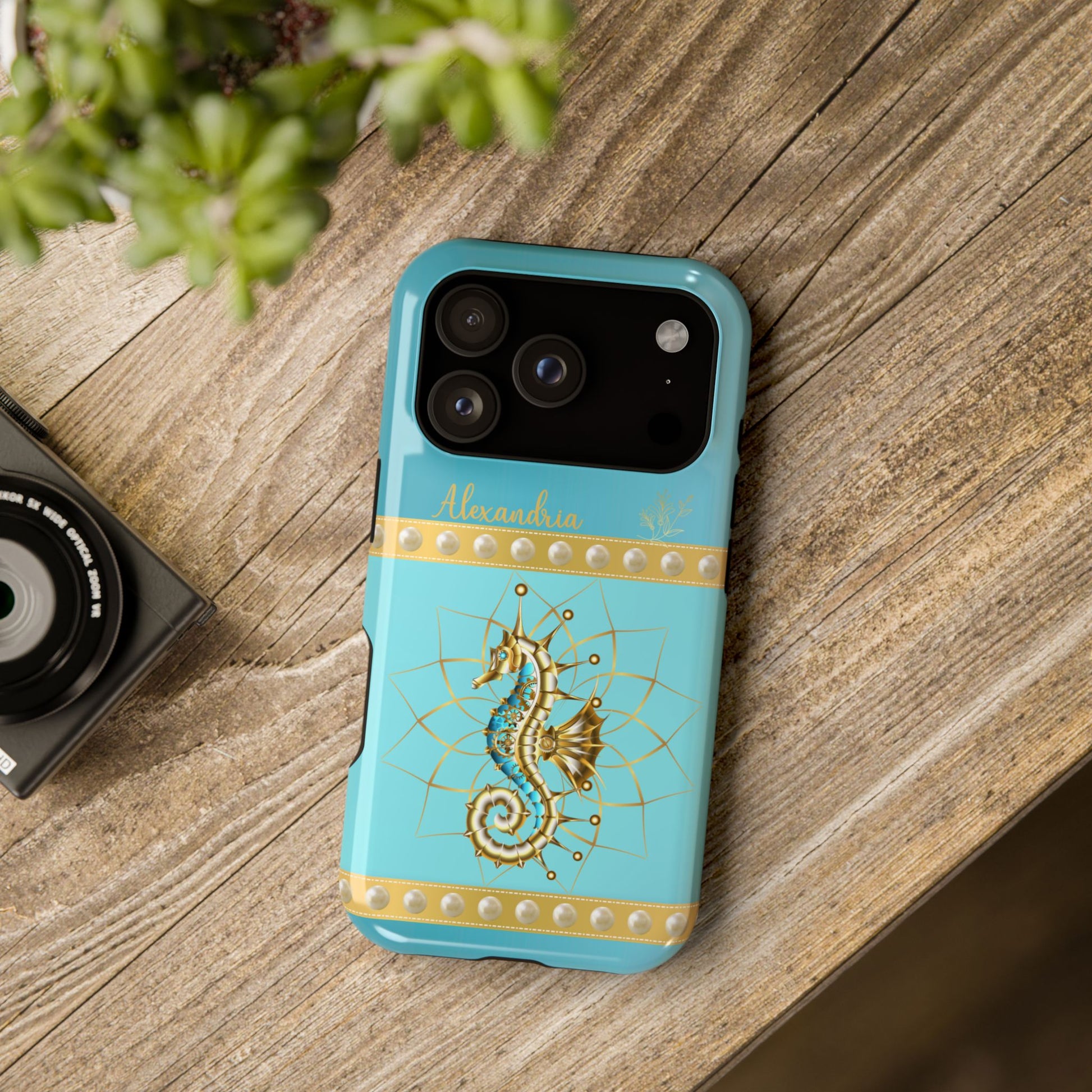 Phone case with seahorse design and 'personalized' text on a teal blue background.