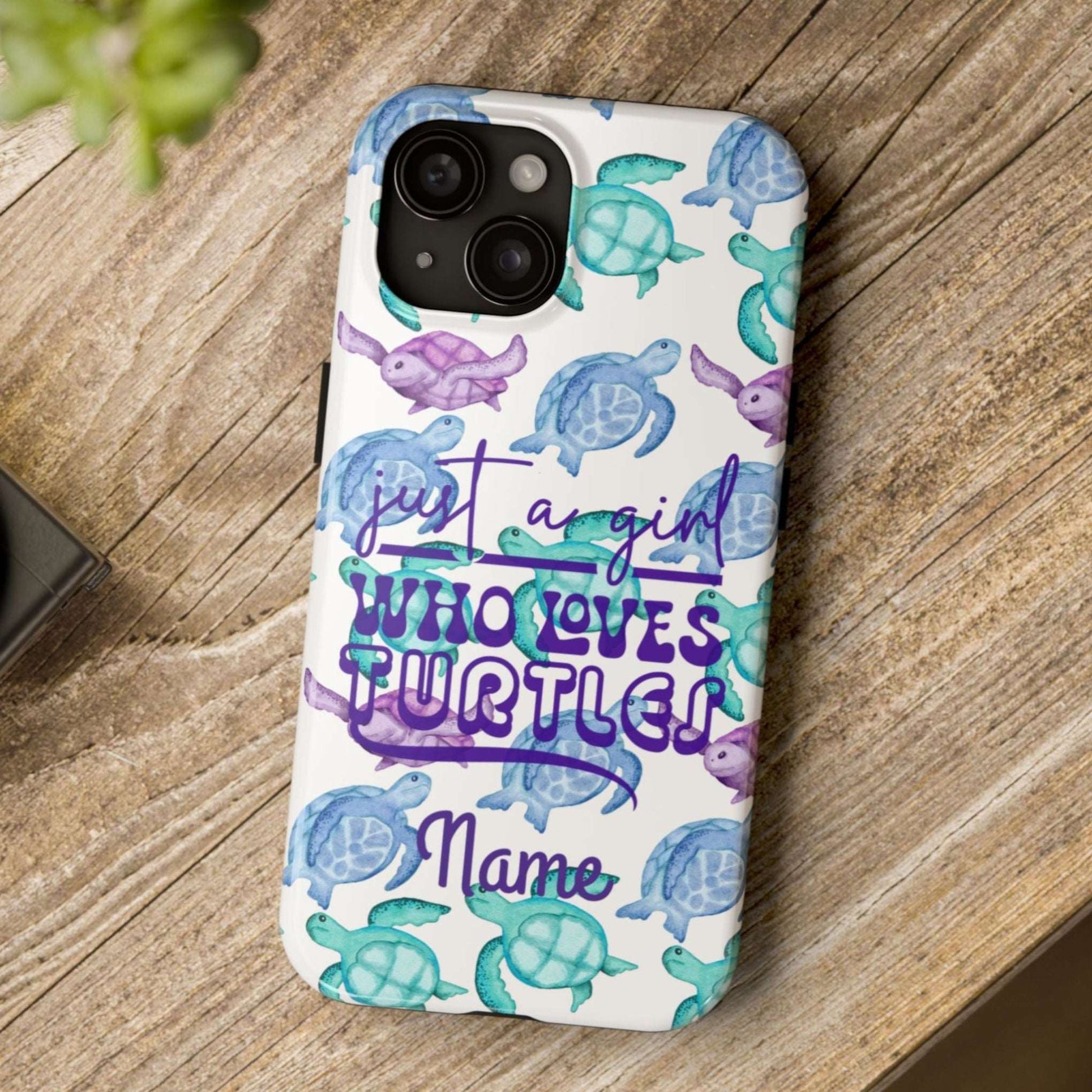 Phone case with turtle design and text on a wooden surface