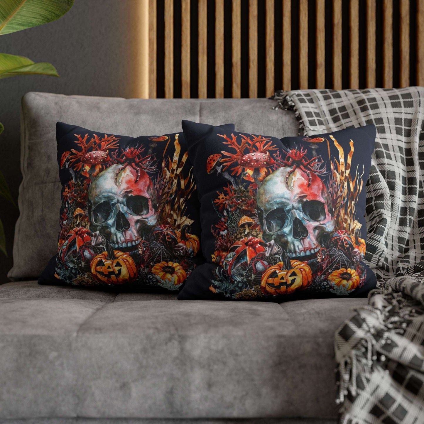 Decorative pillow cases with a double-sided  design of a skull and pumpkins design on a dark background.