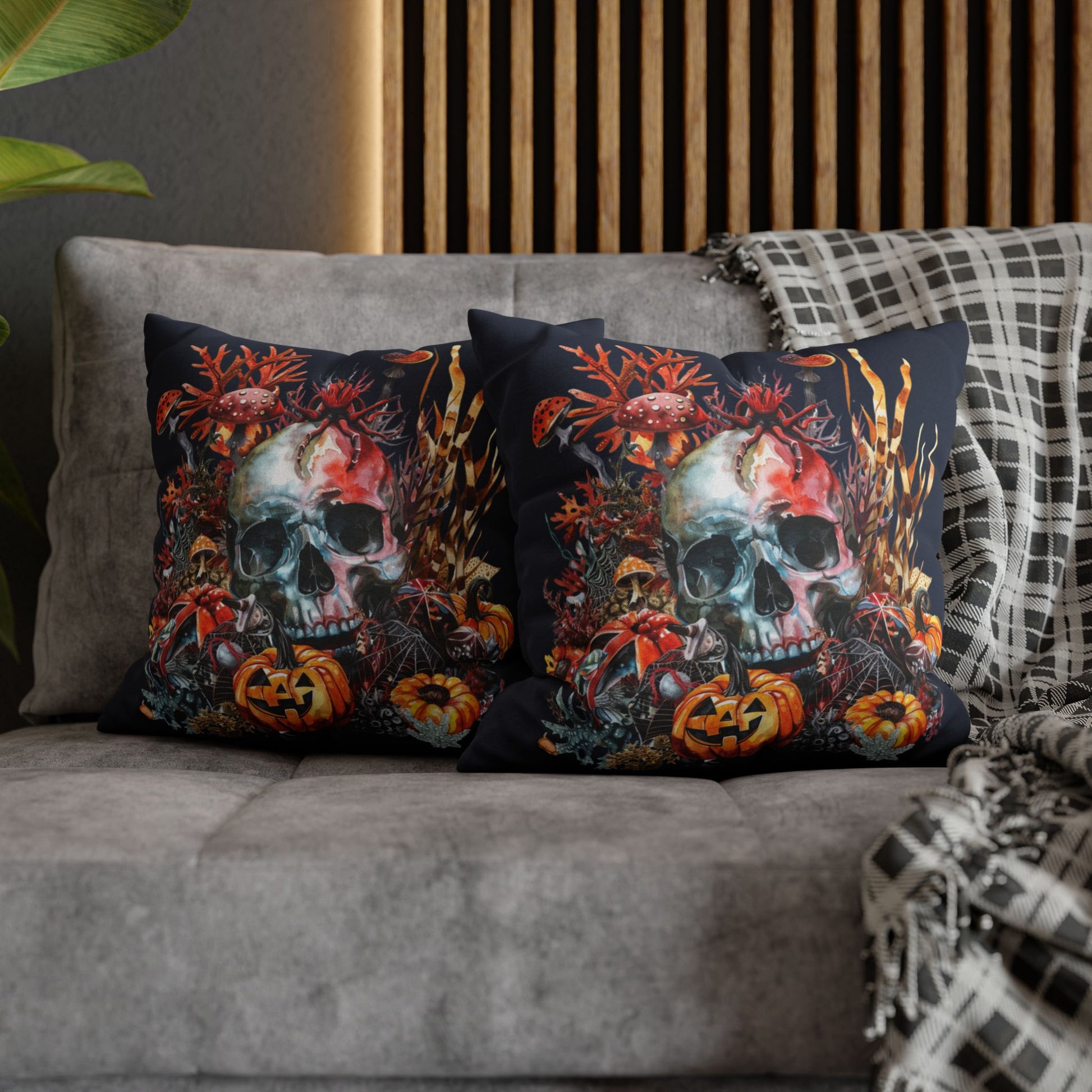 Decorative pillow cases with a double-sided  design of a skull and pumpkins design on a dark background.