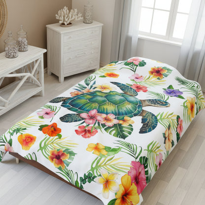 Cozy tropical velveteen 60x80 throw blanket featuring a sea turtle surrounded by colorful hibiscus flowers and palm leaves, perfect for beachy home decor.