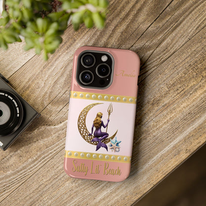 Phone case with a design of a mermaid and crescent moon on a pink background, placed on a wooden surface.