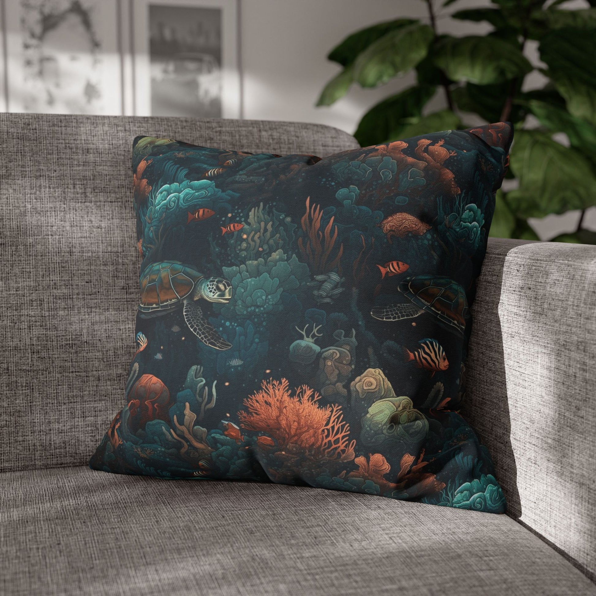 20" x 20" Decorative pillow with underwater scene with sea turtles on a gray couch.