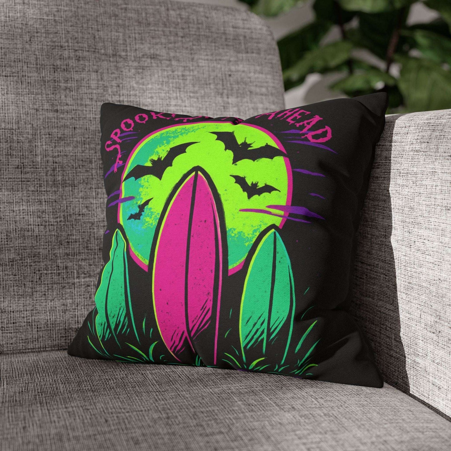 Decorative pillow with Halloween design on a gray couch