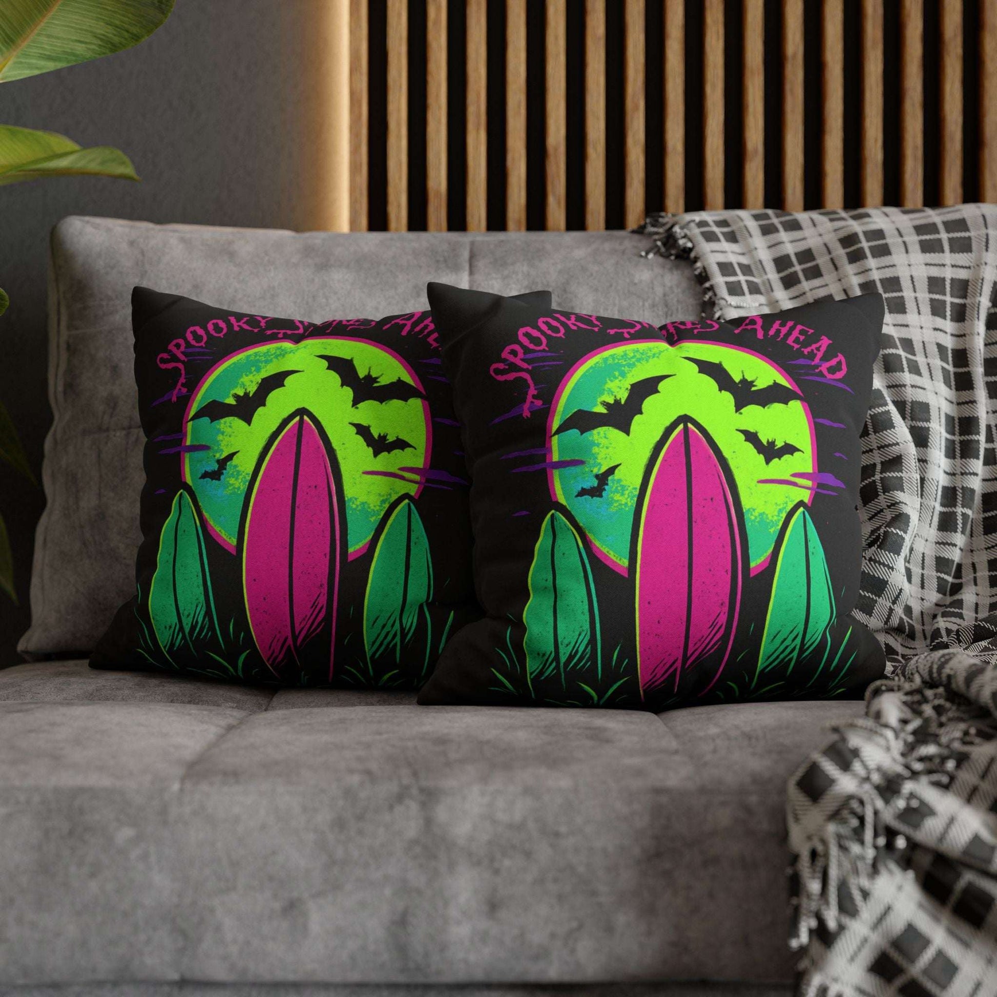Decorative pillow cases with Halloween-themed design on a couch