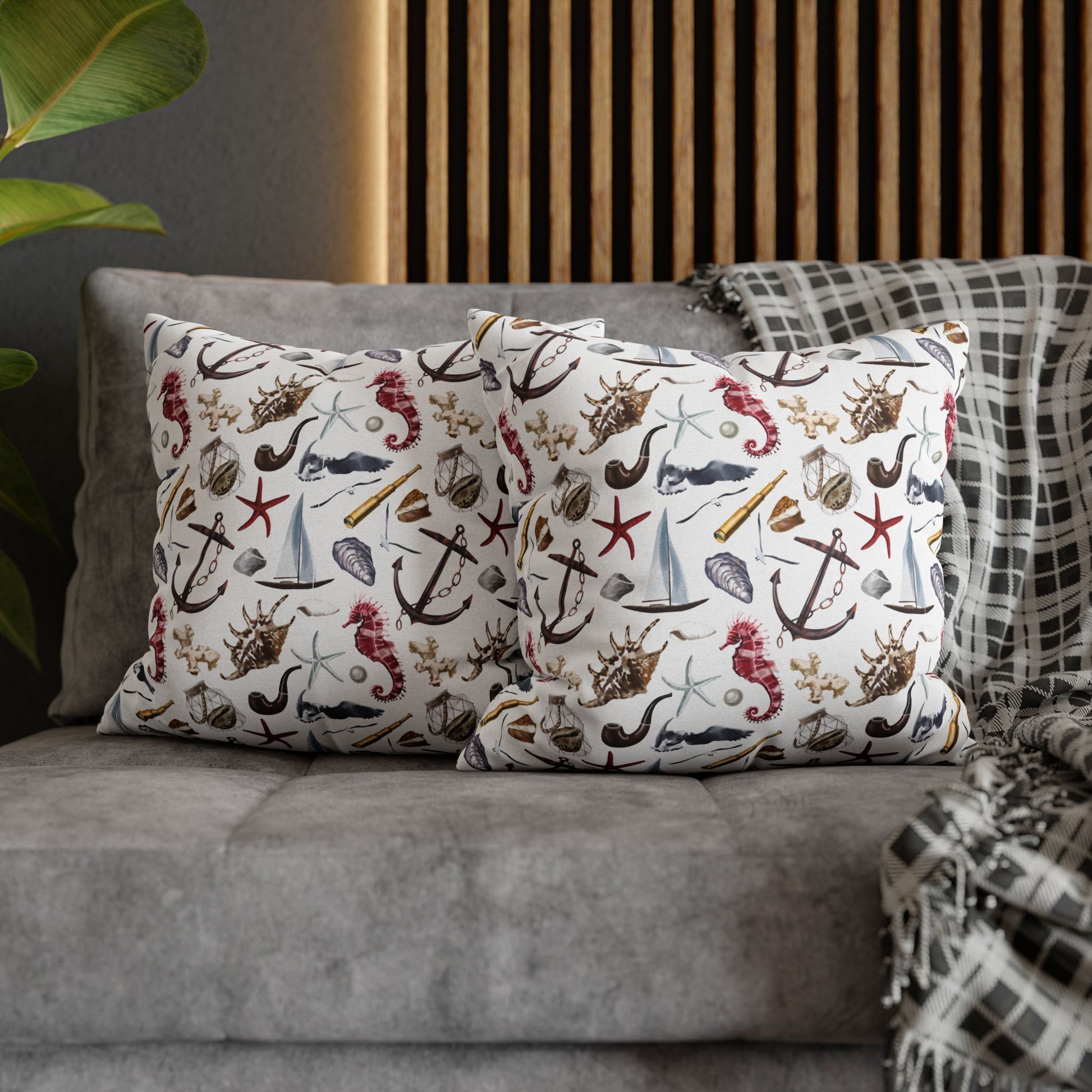 Two 18" x 18" white pillowcases featuring detailed graphics of anchors, seashells, sailboats, and seahorses in a nautical-themed pattern.