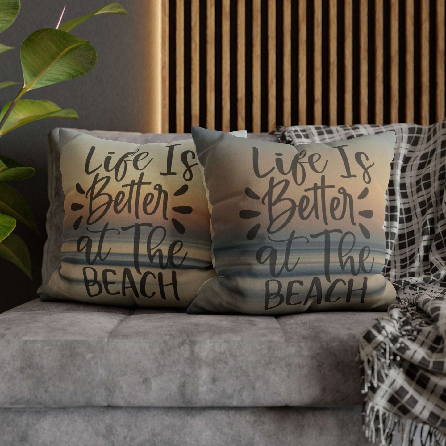 Two pillow cases with 'Life is Better at the Beach' text on a couch.