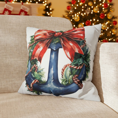 Decorative pillow with a Christmas blue anchor design with a red bow on a couch.
