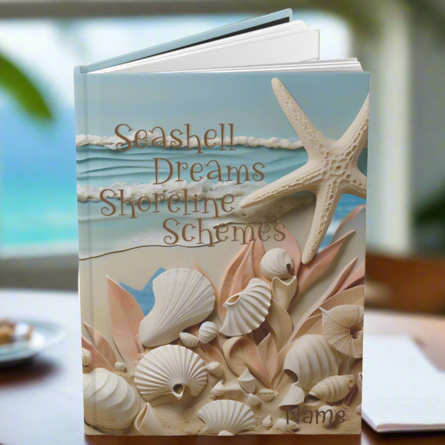 Hardcover Journal with seashells and waves with the text Seashell Creams Shoreline Schemes.