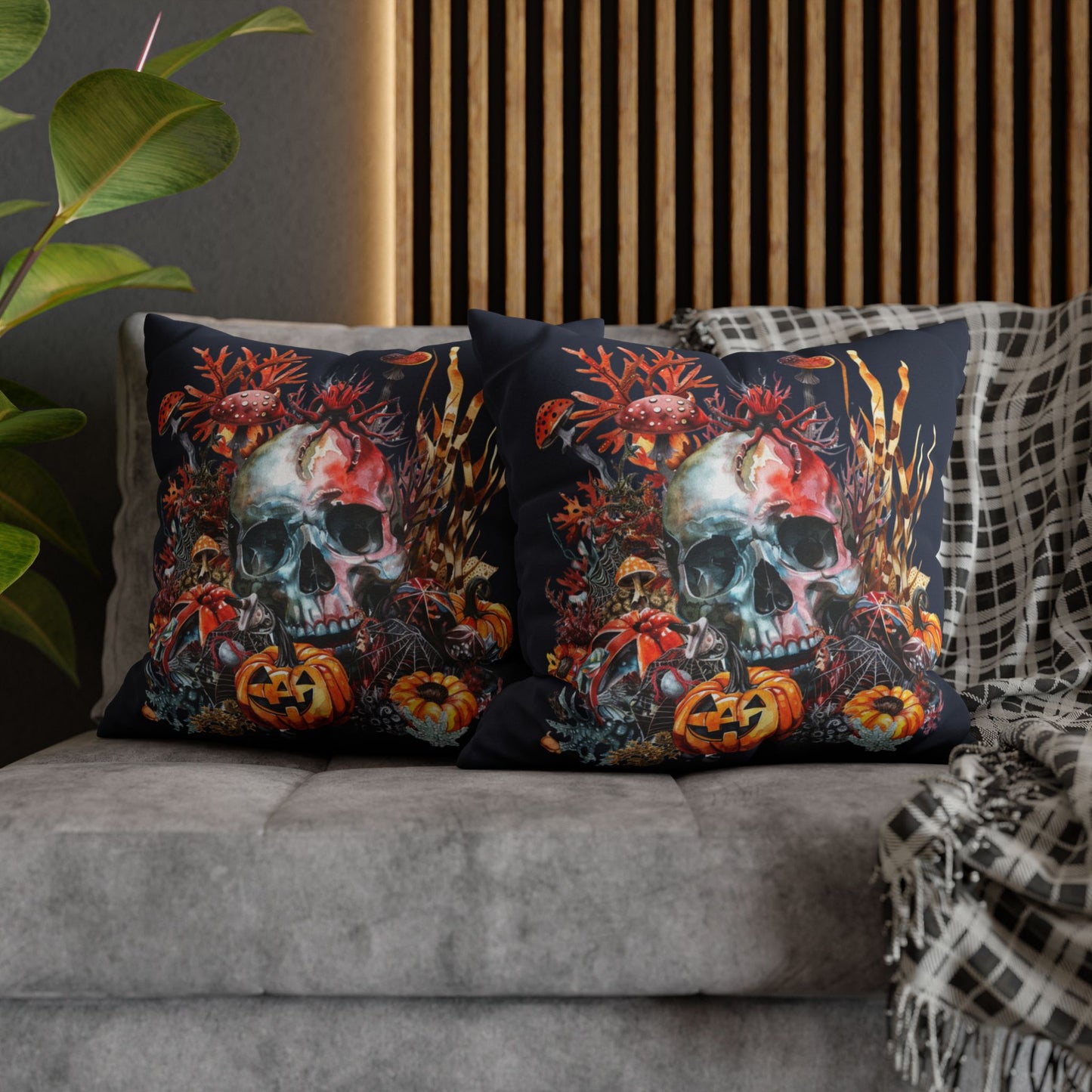 Decorative pillow cases with a double-sided  design of a skull and pumpkins design on a dark background.