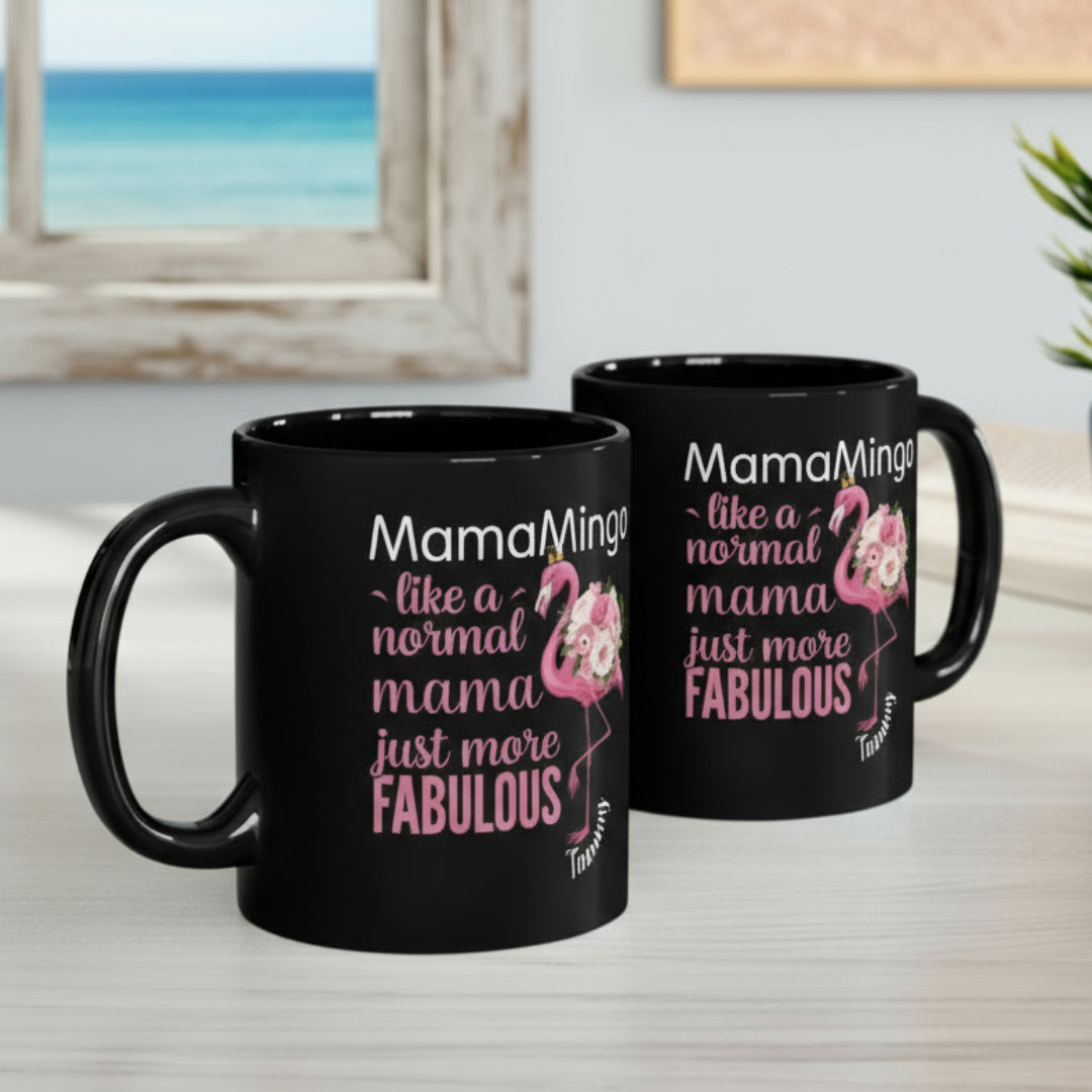 Two black mugs with flamingo design and text on a desk.