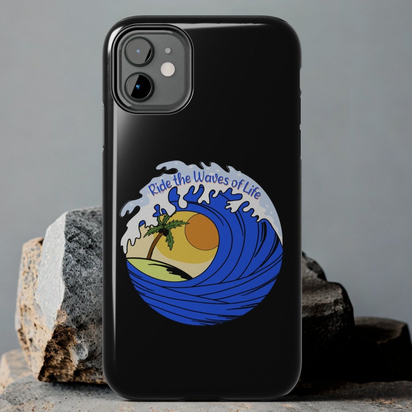 a black Iphone Tough Case with a blue wave and sunset that says Ride the Waves of Life