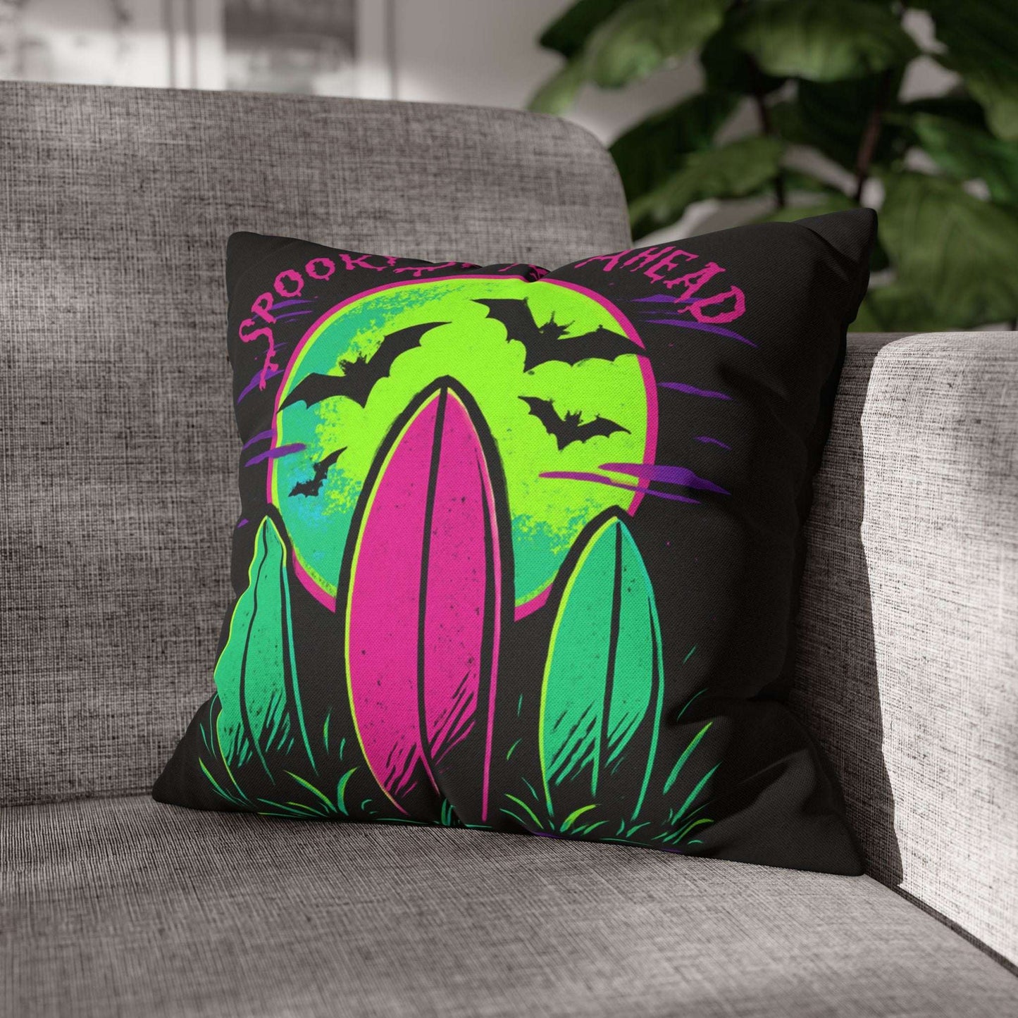 Decorative pillow with Halloween design on a gray couch