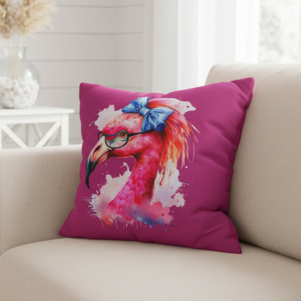 Pink pillow with a colorful flamingo design on a beige couch.