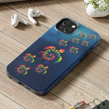 Phone case with colorful spiral design on a wooden surface with laptop, earbuds, and notebook.