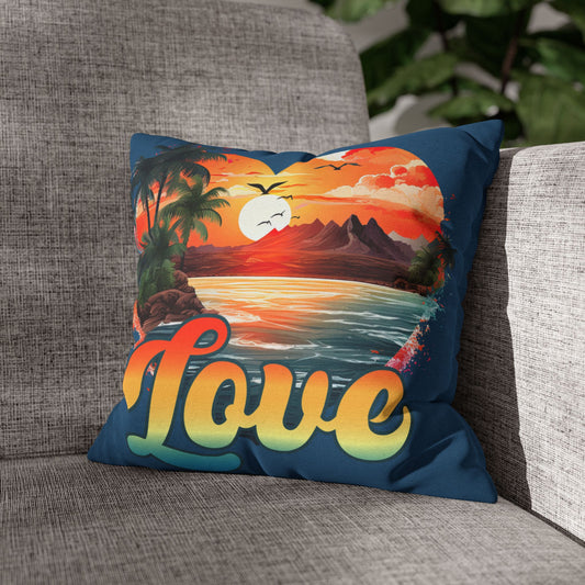 Decorative 14" x 14"blue pillow with a sunset design and 'love' text on a gray couch.