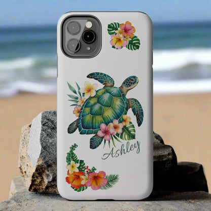 iPhone 13 case with a white background and a sea turtle with hibiscus flowers, with more hibiscus flowers around the sides.
