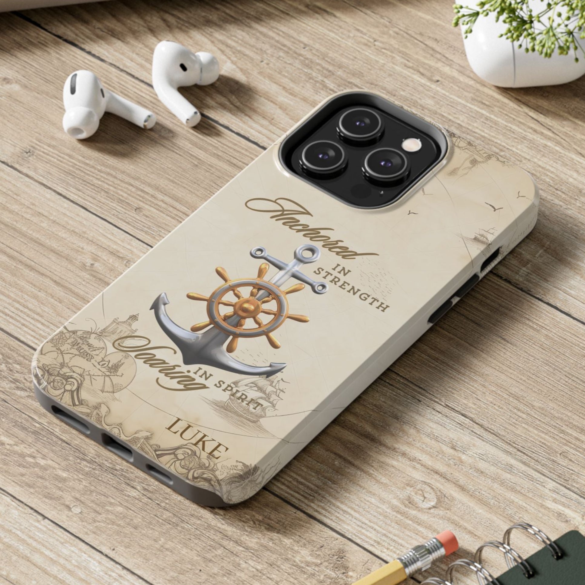 Phone case with anchor and ship wheel design with text 'Anchored in Strength soaring in Spirit' that can be personalized.