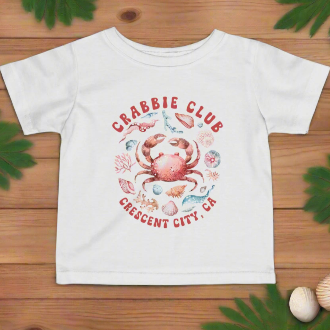 White t-shirt with a crab graphic and 'Crabbie Club' Crescent City, CA.