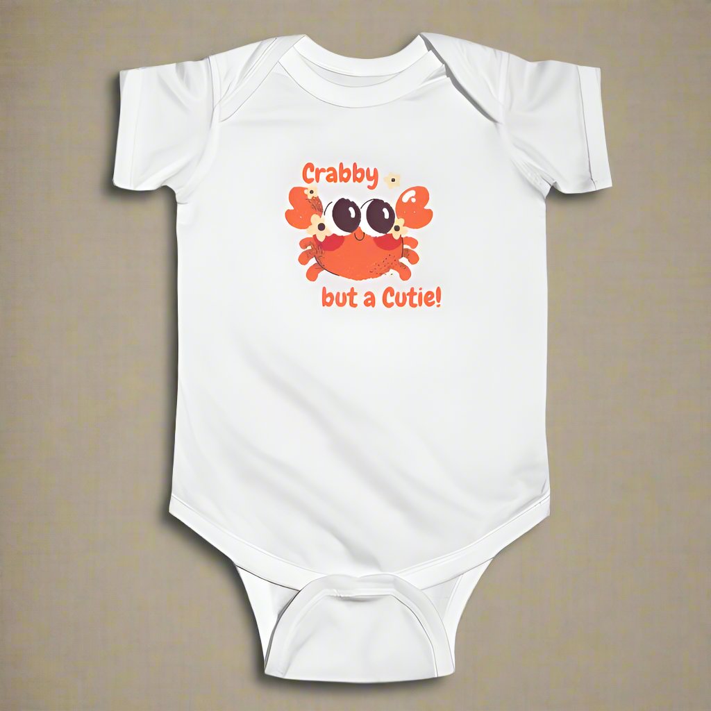 White short sleeved body suit with cartoon crab that says crabby but a cutie studio picture