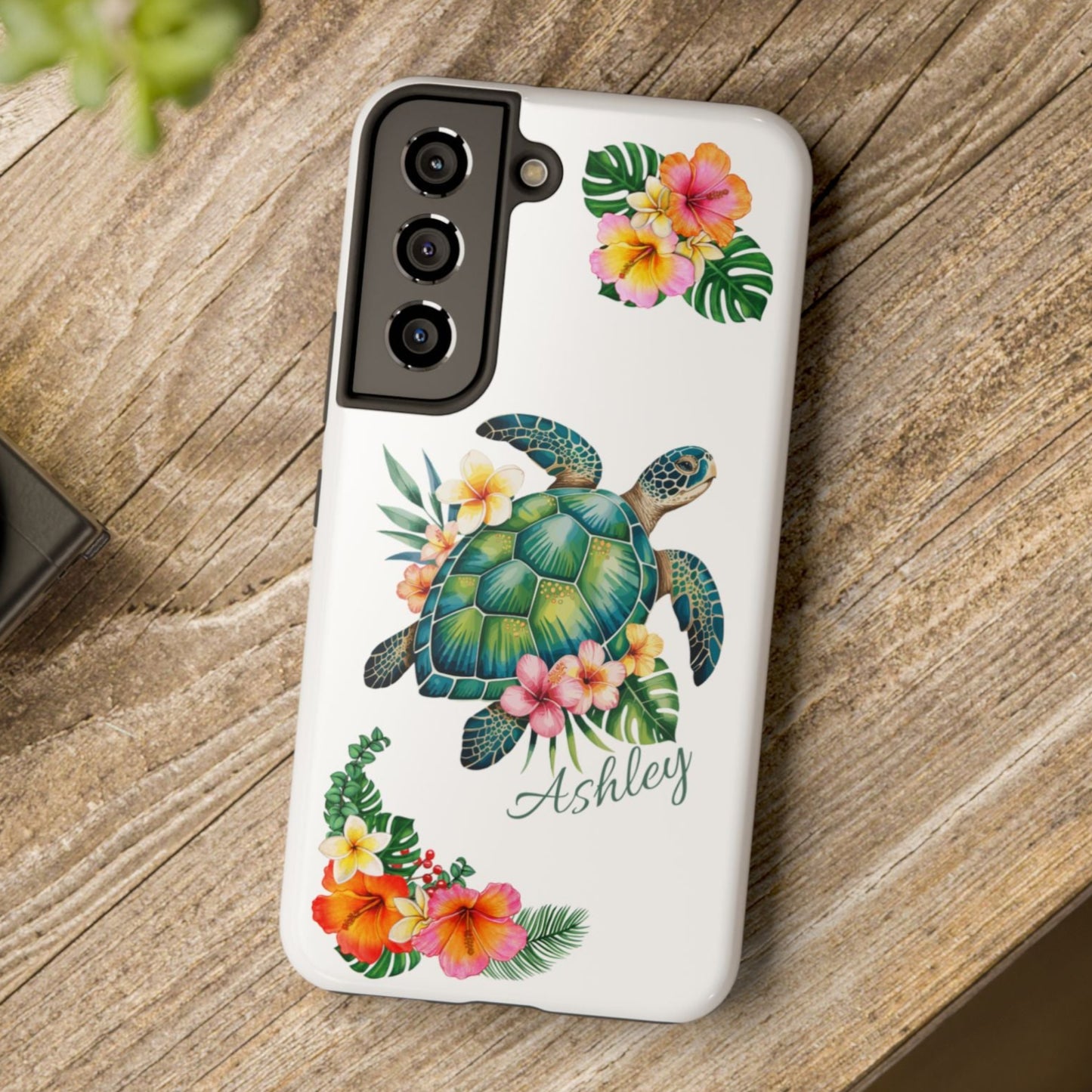 Samsung phone case with a white background and a sea turtle with hibiscus flowers, with more hibiscus flowers around the sides.