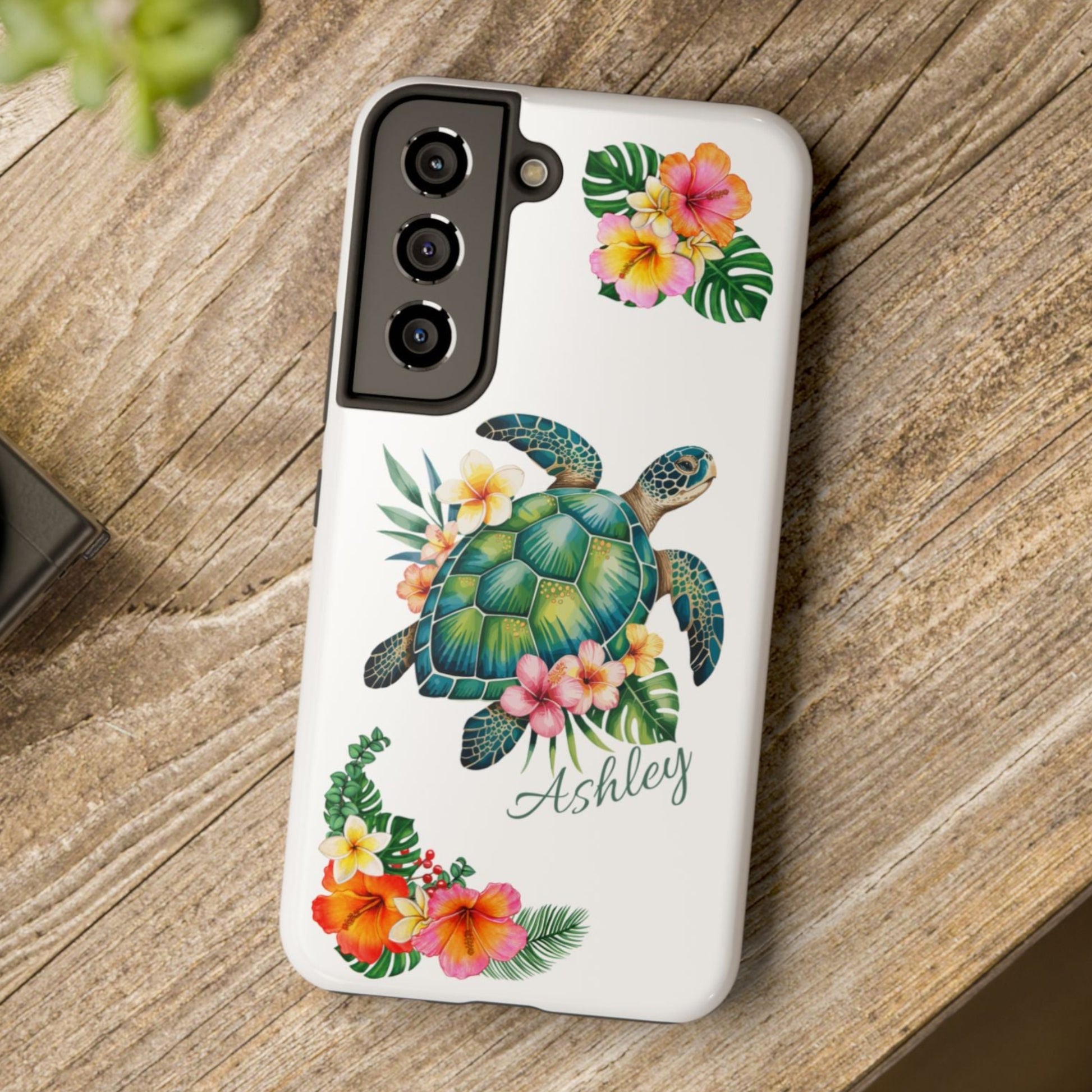 Samsung phone case with a white background and a sea turtle with hibiscus flowers, with more hibiscus flowers around the sides.