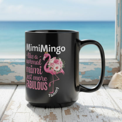 Black mug with flamingo design and text on a white surface