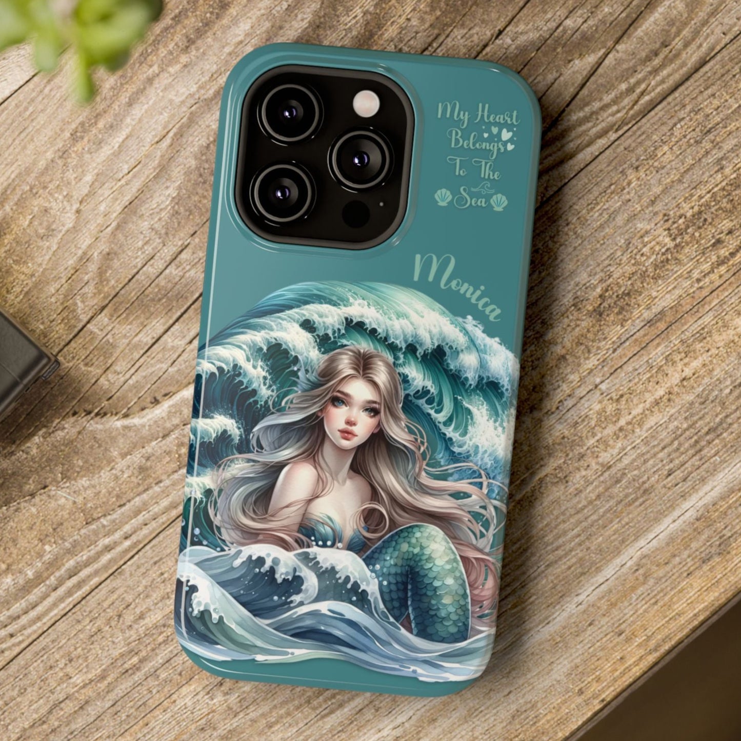 Phone case with mermaid design on a wooden surface