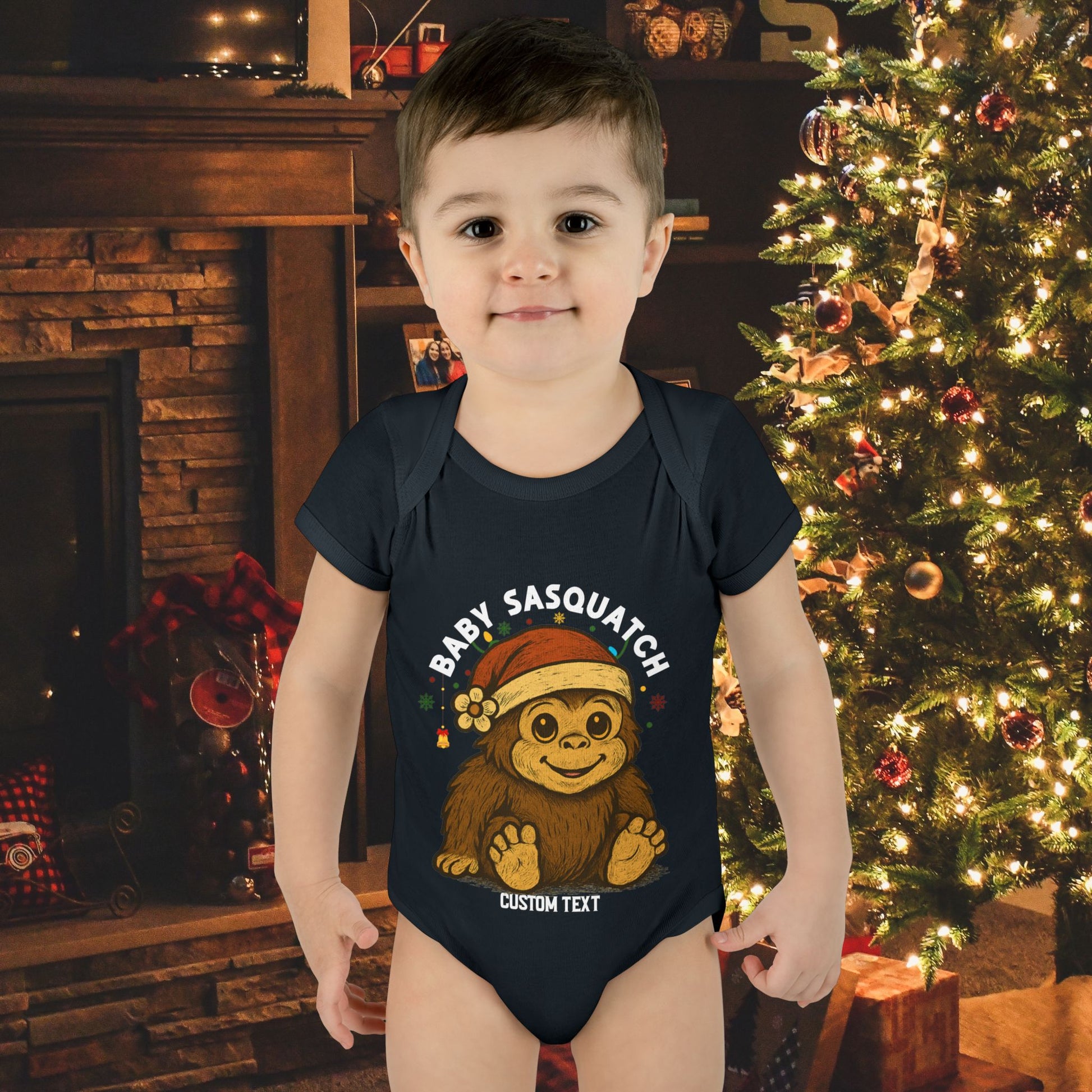 Child wearing a 'Baby Sasquatch' onesie with custom text.