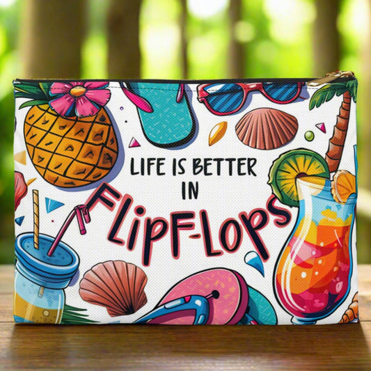 White accessories bag with black zipper and colorful beach graphics that says Life is Better in Flip Flops