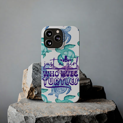 Iphone case with turquoise, blue and purple sea turtles that says  Just a Girl Who Loves Sea turtles laying against rock