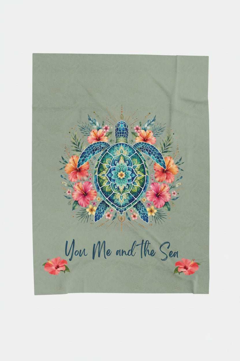 An ultra-soft plush 50x60" blanket featuring a vibrant mandala sea turtle surrounded by tropical hibiscus flowers with the phrase "You, Me and the Sea" on a sage-green background.