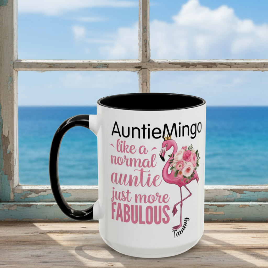 White mug with black interior and handle, featuring a flamingo graphic and text.
