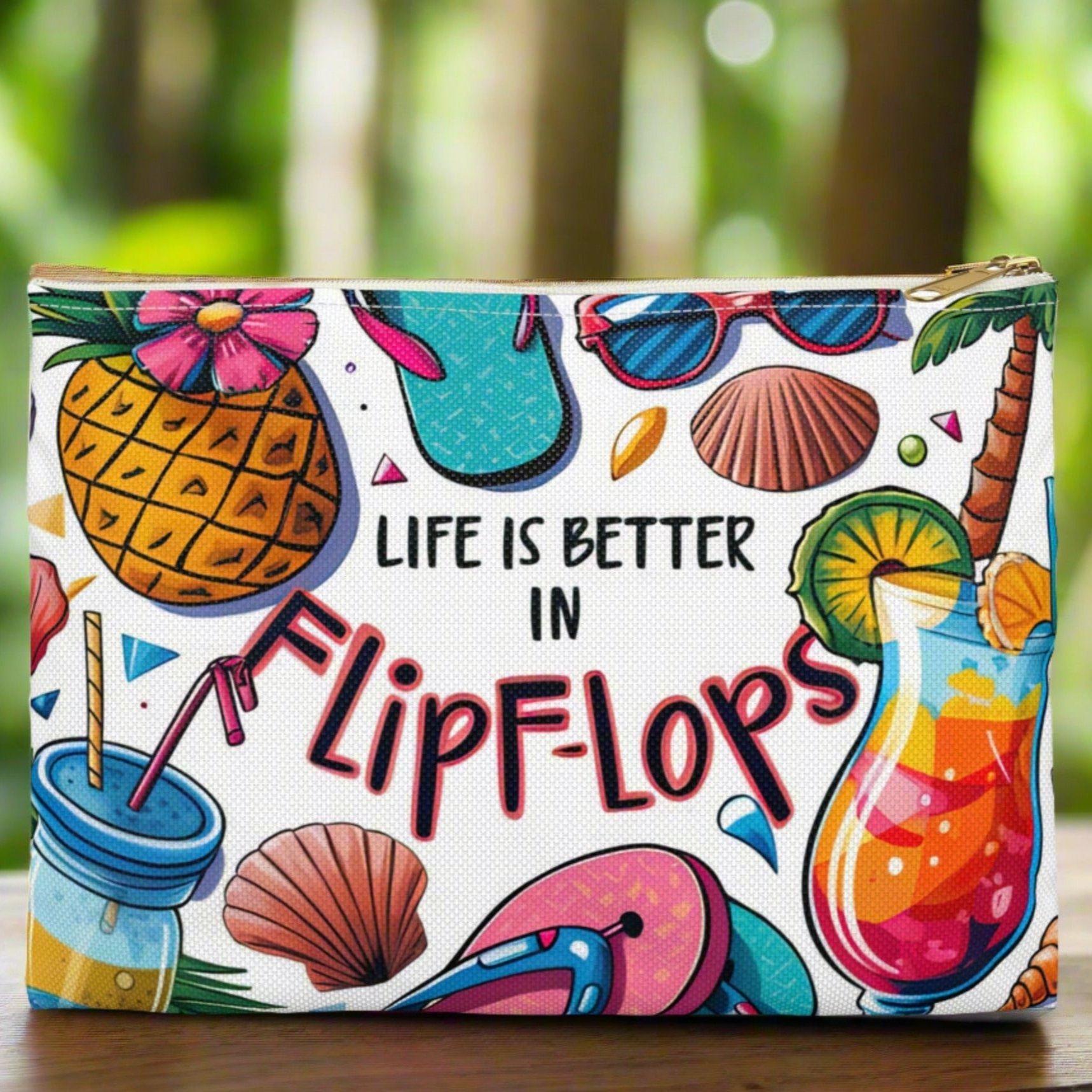 White accessories bag with white zipper and colorful beach graphics that says Life is Better in Flip Flops